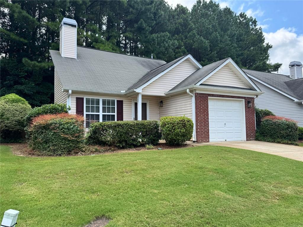 204 Park Place Woodstock, GA 30189 - Photo 1 of 22 a front view of a house with a yard and garage
