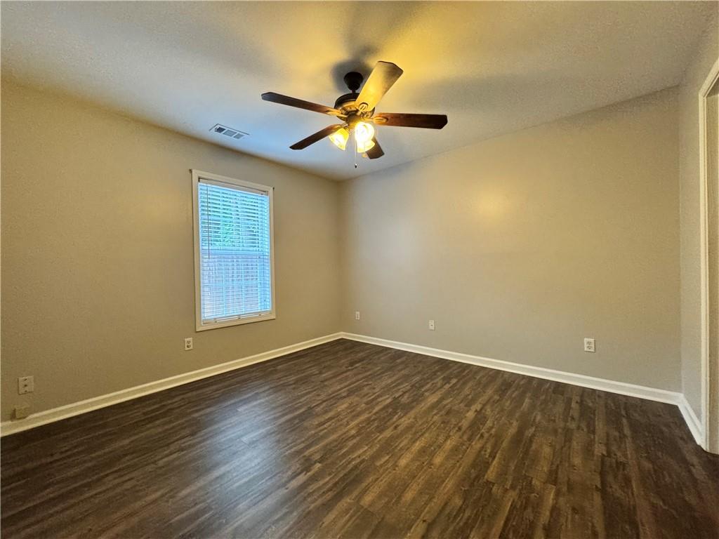 204 Park Place Woodstock, GA 30189 - Photo 11 of 22 a view of an empty room with wooden floor and a window