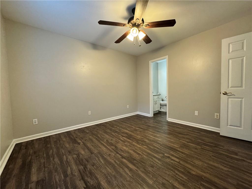 204 Park Place Woodstock, GA 30189 - Photo 12 of 22 an empty room with wooden floor and windows