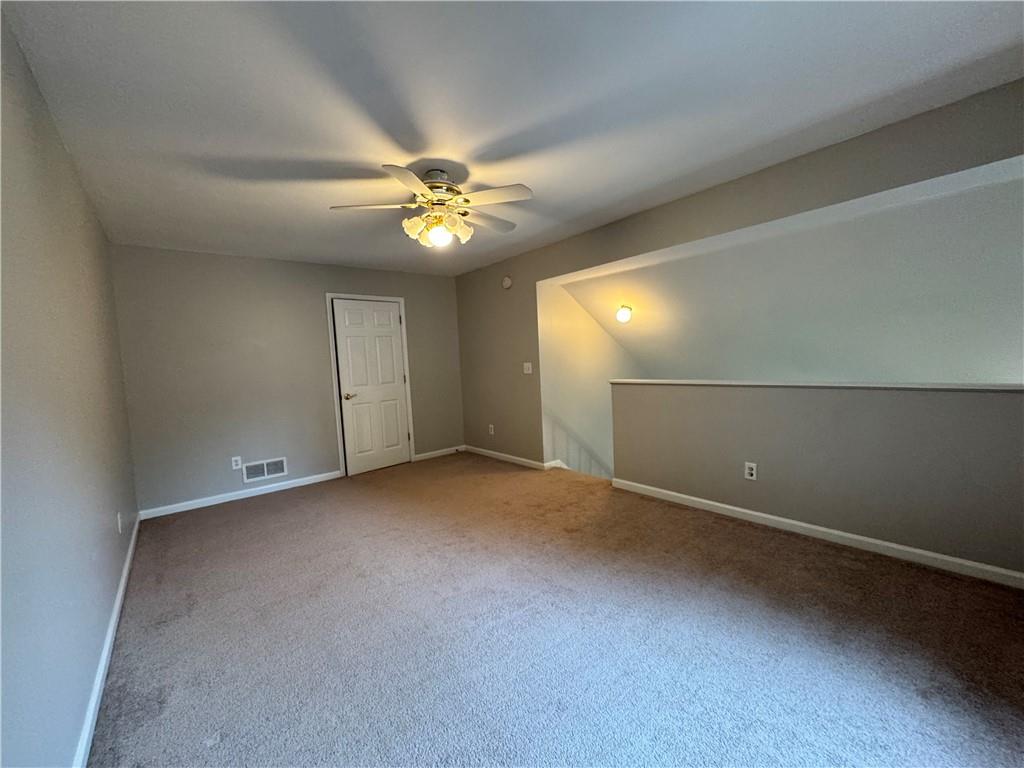 204 Park Place Woodstock, GA 30189 - Photo 17 of 22 an empty room with a fan & a ceiling fan
