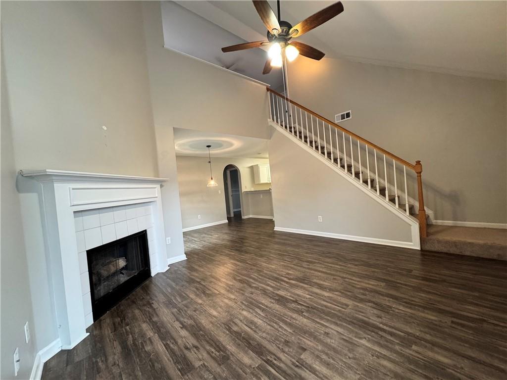 204 Park Place Woodstock, GA 30189 - Photo 3 of 22 a view of an empty room with wooden floor a fireplace and a window