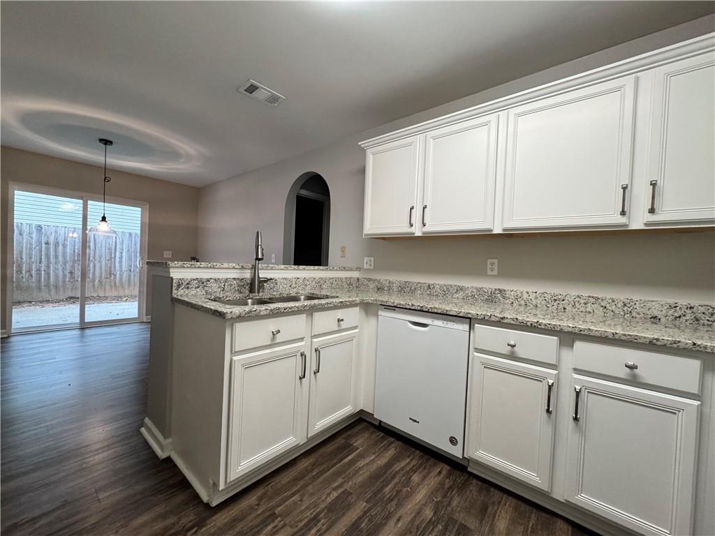 204 Park Place Woodstock, GA 30189 - Photo 7 of 22 a kitchen with granite countertop white cabinets and a sink