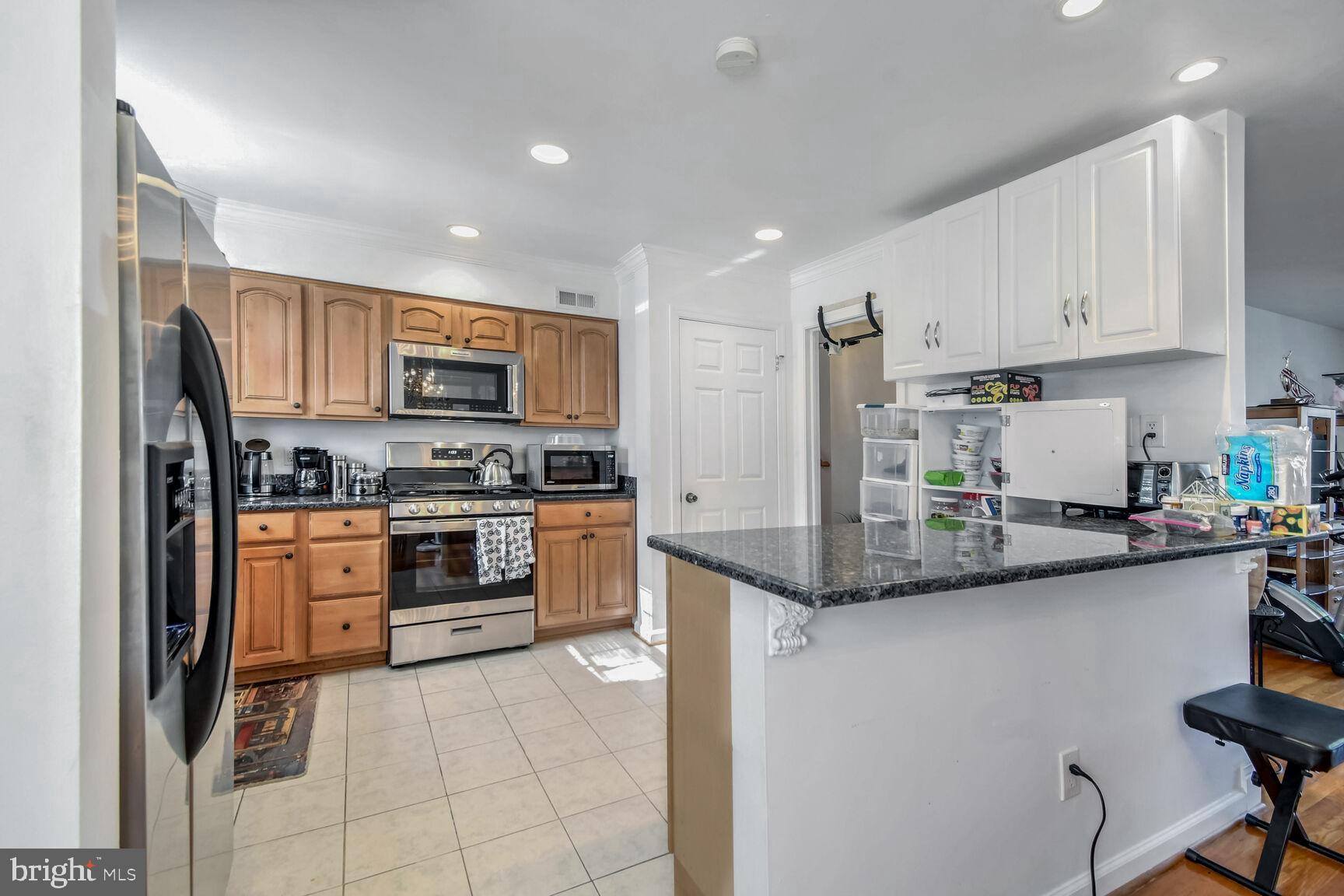 1113 Brantford Avenue Silver Spring, MD 20904 - Photo 11 of 35 a kitchen with stainless steel appliances granite countertop a stove top oven a sink and dishwasher
