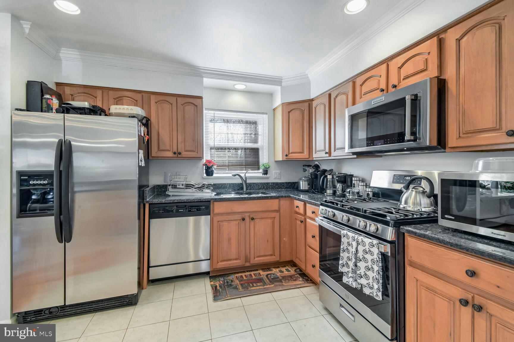 1113 Brantford Avenue Silver Spring, MD 20904 - Photo 12 of 35 a kitchen with stainless steel appliances granite countertop a refrigerator stove and sink