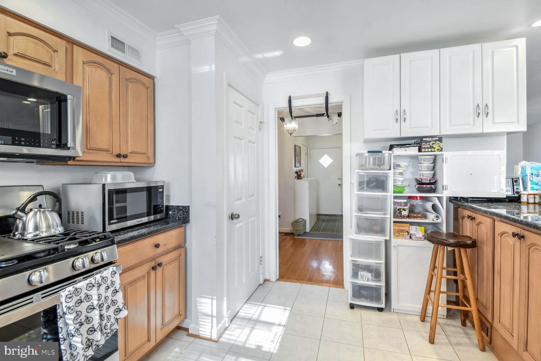 1113 Brantford Avenue Silver Spring, MD 20904 - Photo 13 of 35 a kitchen with granite countertop a refrigerator and a stove top oven