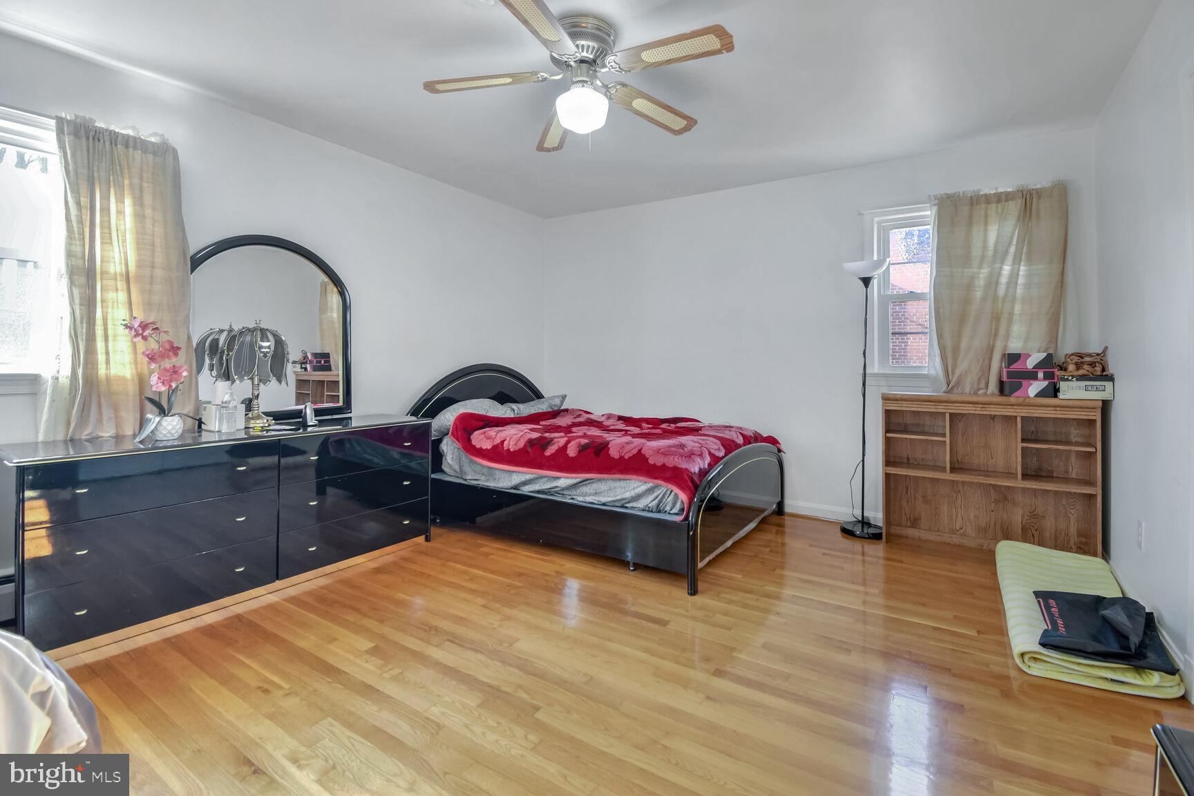1113 Brantford Avenue Silver Spring, MD 20904 - Photo 14 of 35 a bedroom with a bed and dresser with mirror