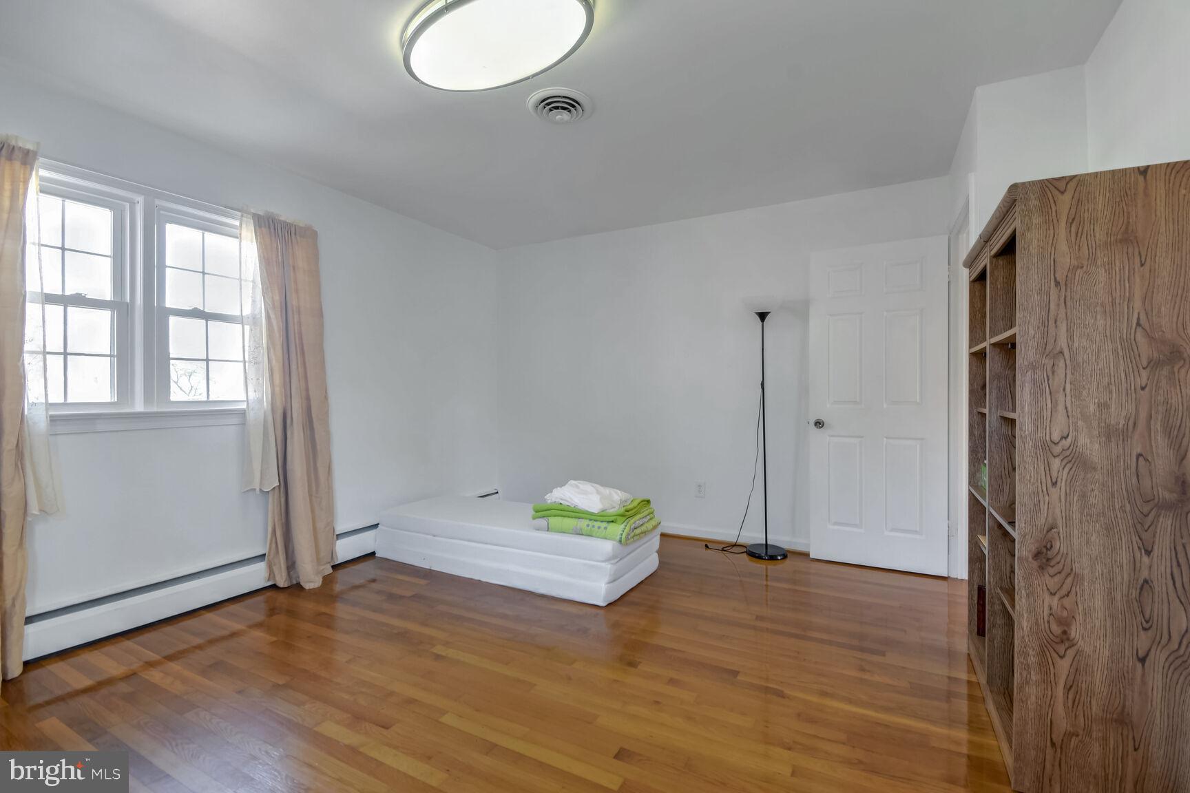 1113 Brantford Avenue Silver Spring, MD 20904 - Photo 17 of 35 an empty room with wooden floor and windows