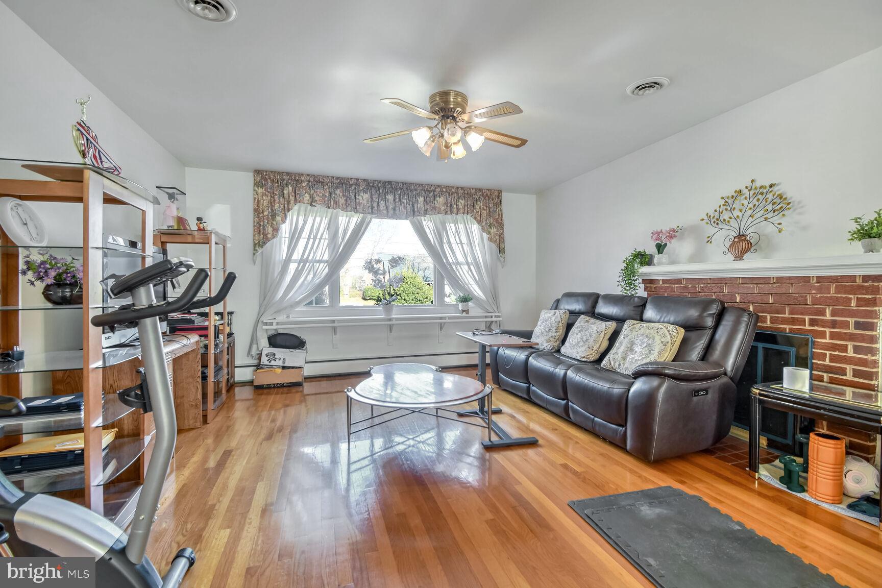 1113 Brantford Avenue Silver Spring, MD 20904 - Photo 6 of 35 a living room with furniture and a wooden floor