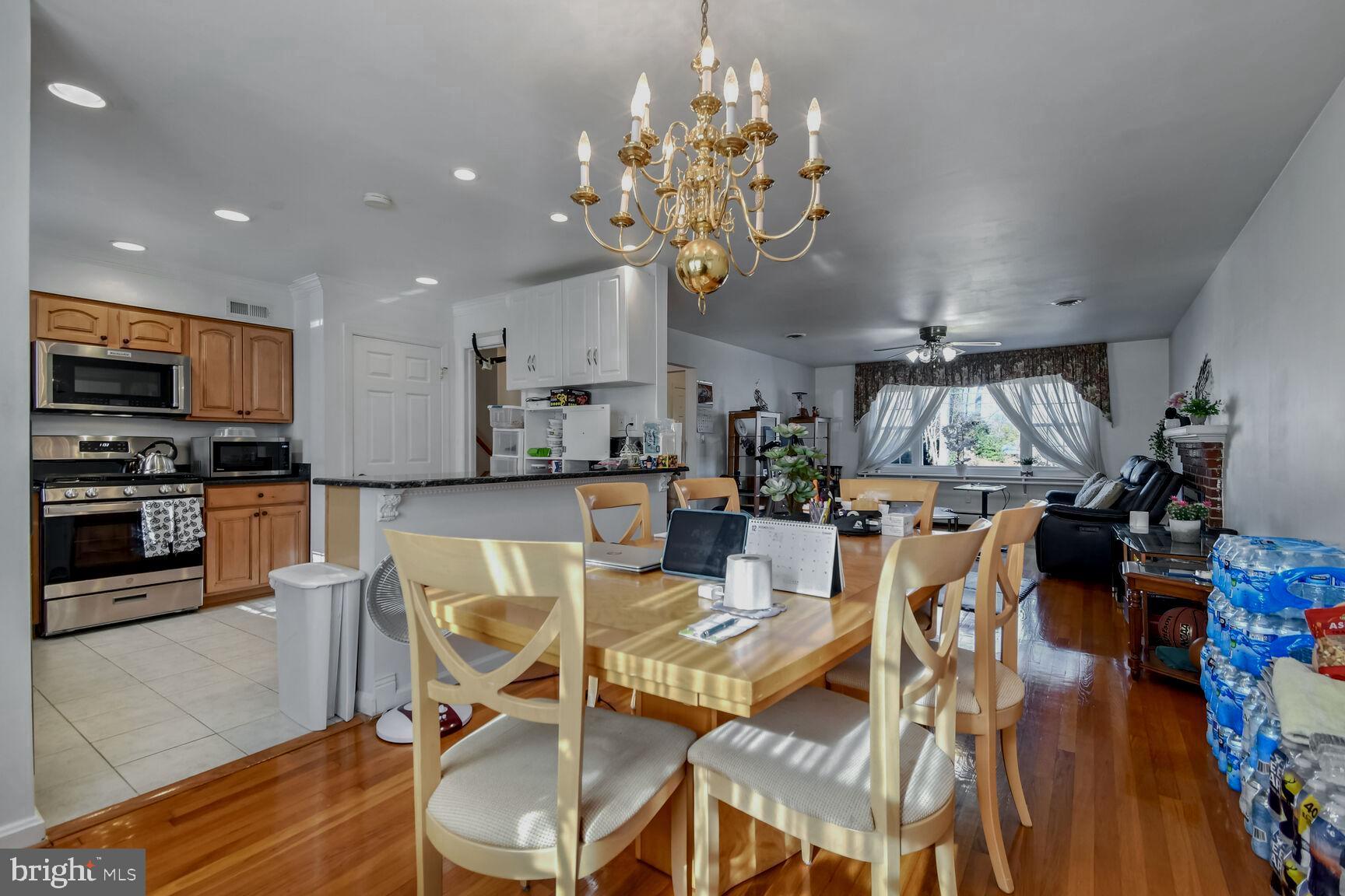 1113 Brantford Avenue Silver Spring, MD 20904 - Photo 10 of 35 a view of a dining room and livingroom with furniture wooden floor kitchen view and a chandelier
