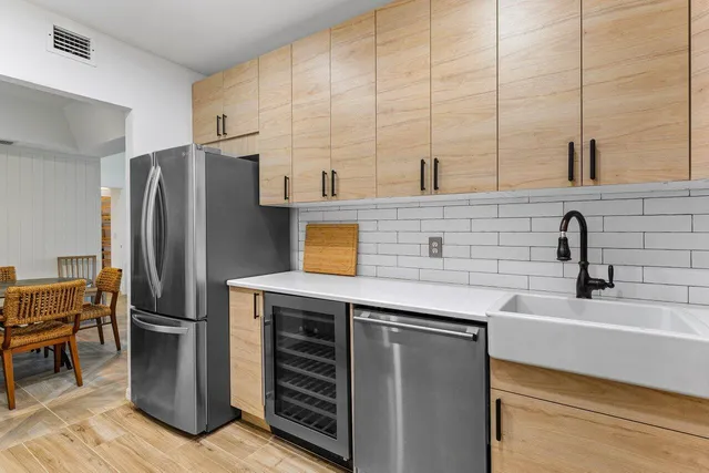 a kitchen with stainless steel appliances a refrigerator and a sink