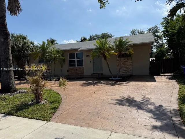 a front view of a house with a yard and a garage