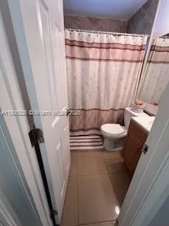 a view of bathroom with a shower and toilet