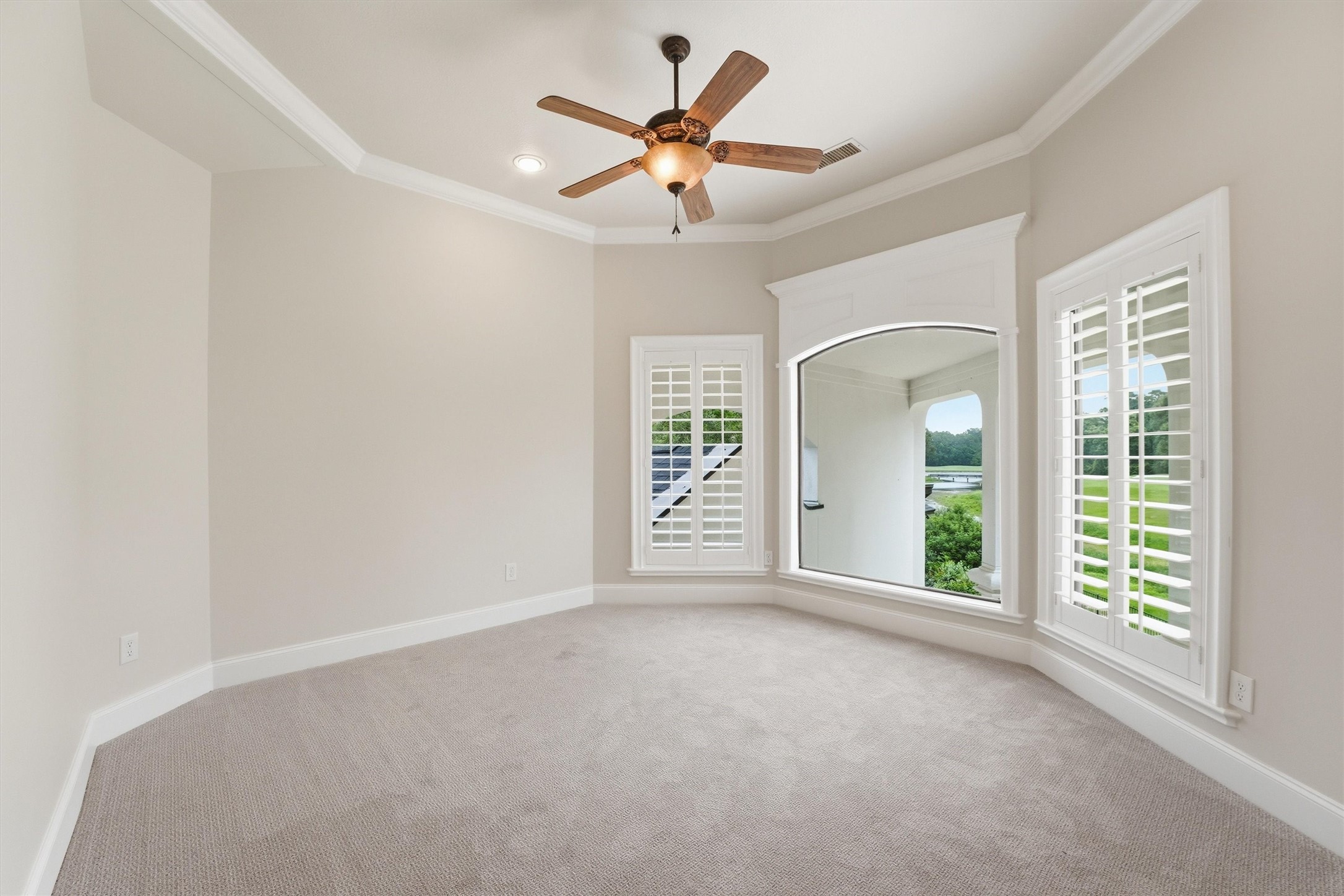 70 Quail Rock Place The Woodlands, TX 77381 - Photo 28 of 46 an empty room with fan and windows