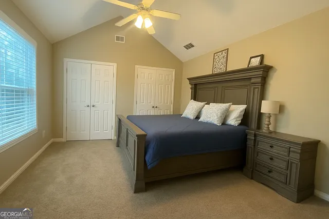 a bedroom with a bed and a dresser
