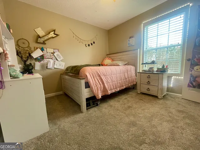 a bed room with a bed and a chair