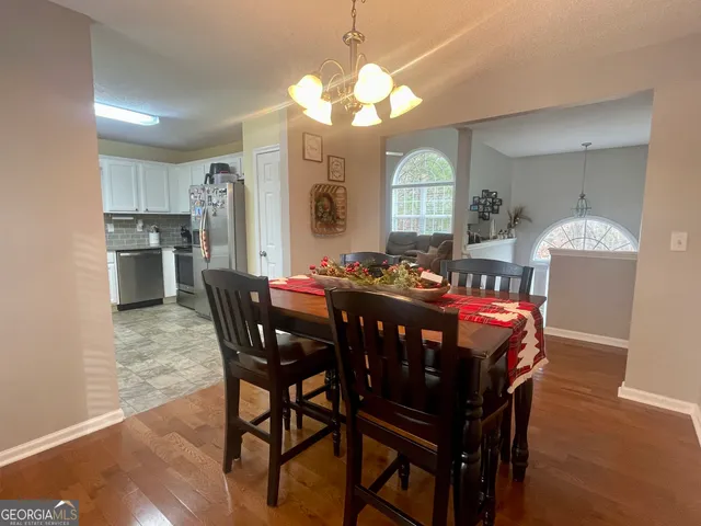 a view of a dining room with furniture and a chandelier