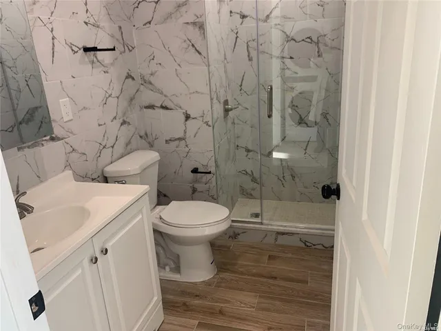 a white toilet sitting next to a bathroom sink