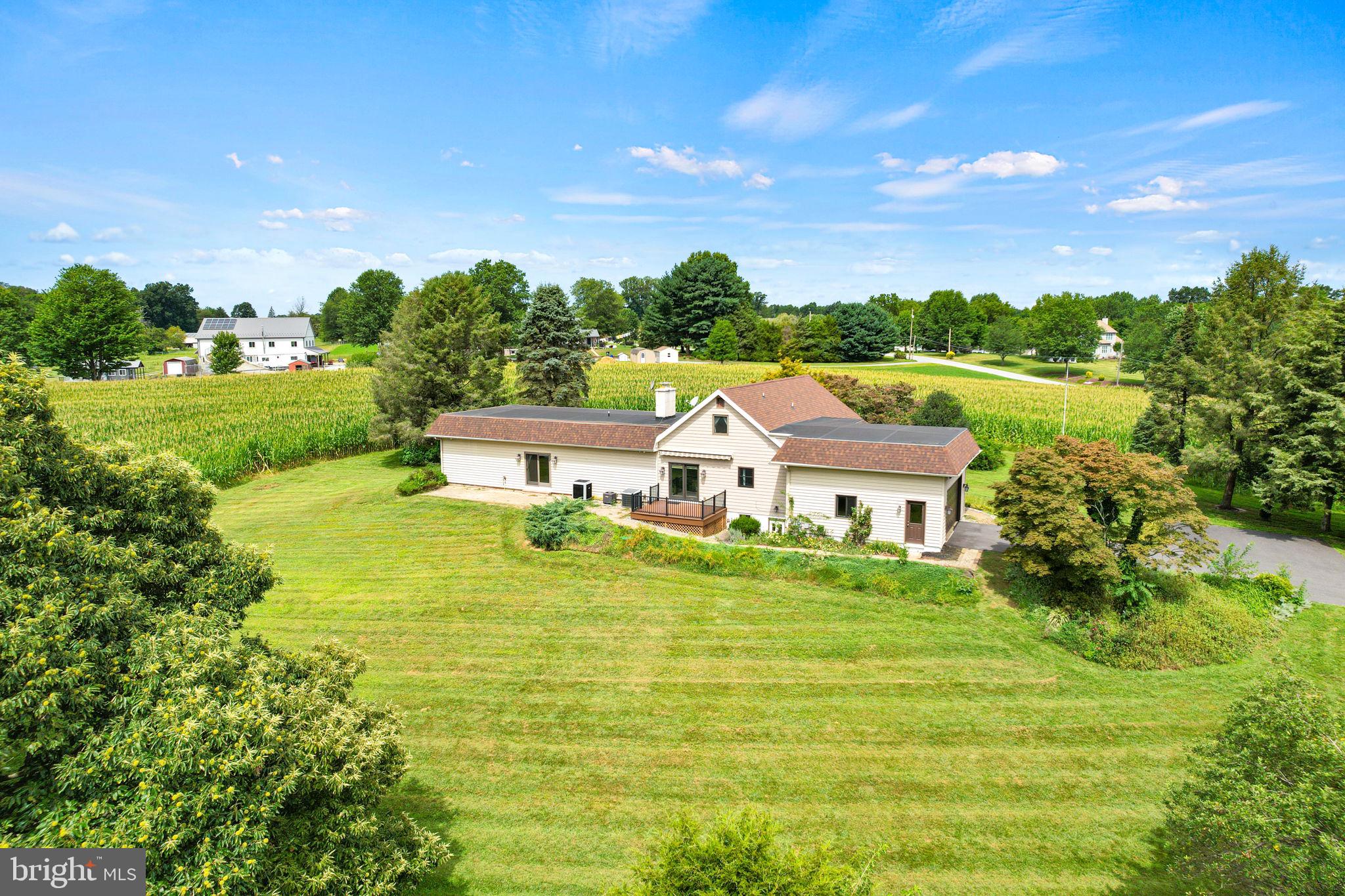a view of a big house with a big yard