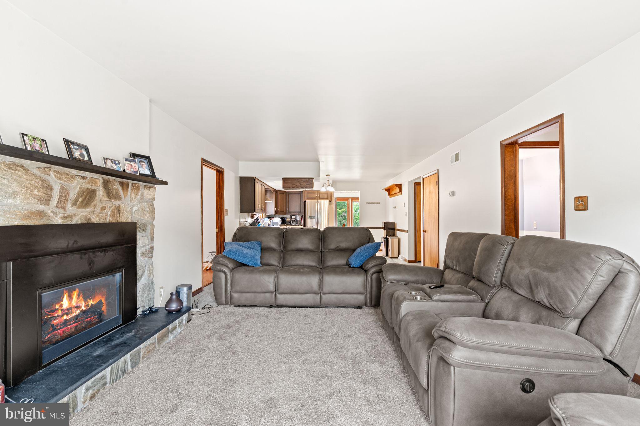 170 Sunset Road Oxford, PA 19363 - Photo 11 of 70 a living room with furniture a fireplace and a flat screen tv
