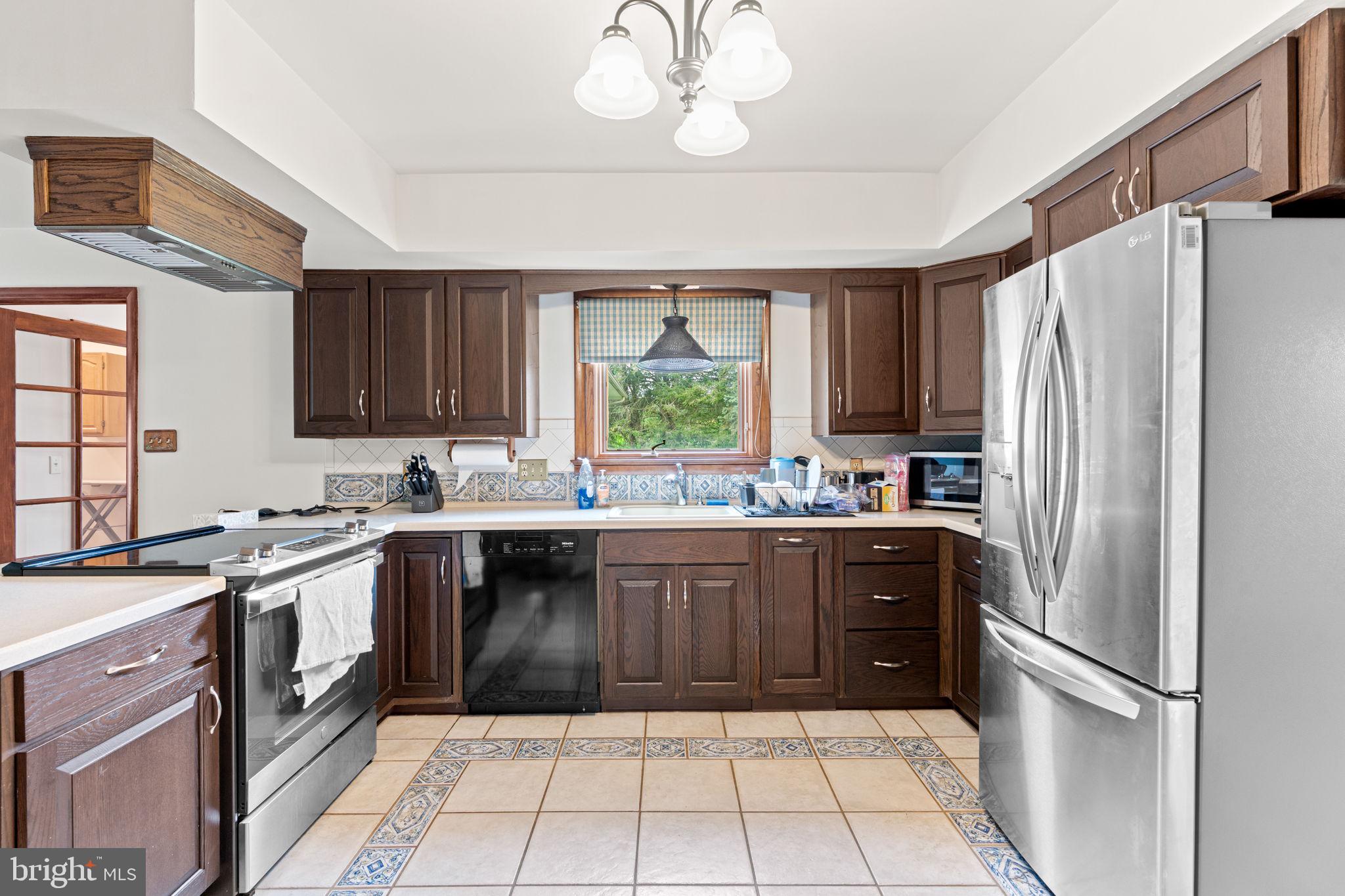 170 Sunset Road Oxford, PA 19363 - Photo 13 of 70 a kitchen with a refrigerator a sink dishwasher a refrigerator and cabinets with wooden floor