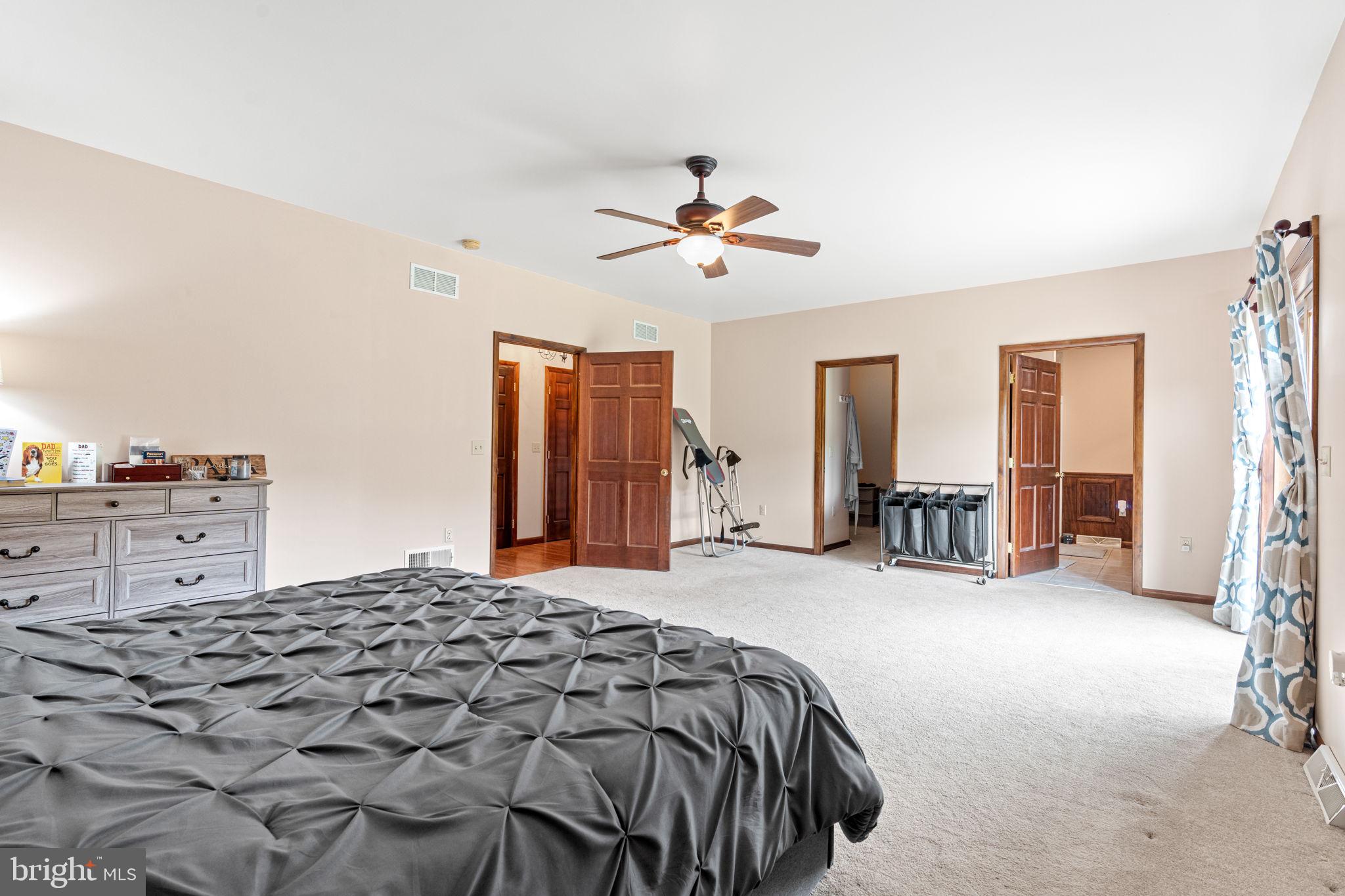 170 Sunset Road Oxford, PA 19363 - Photo 25 of 70 a bedroom with a large bed and a chandelier
