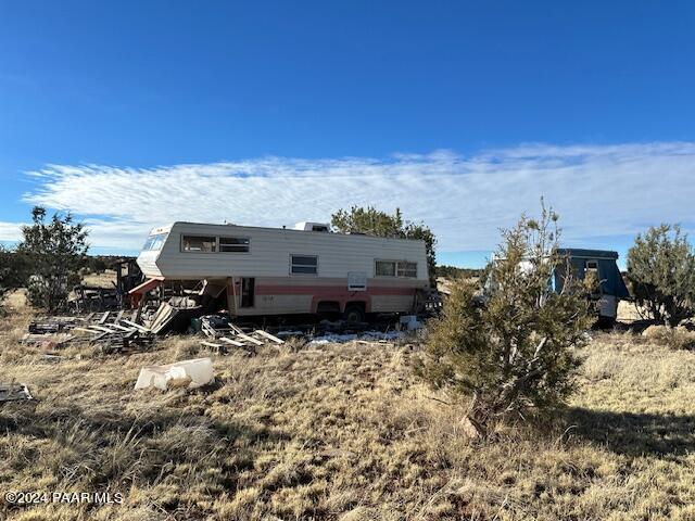 310- Dusty Rose Road Seligman, AZ 86337 - Photo 8 of 10 a view of roof with wooden fence