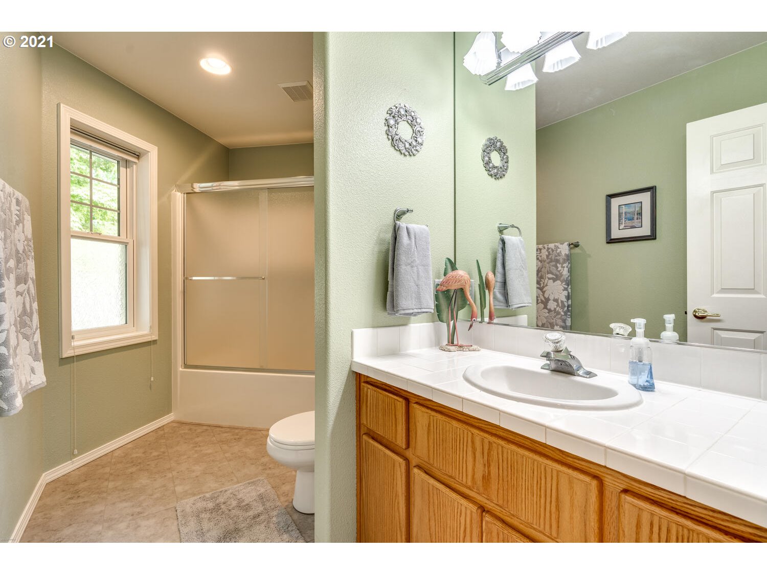 2170 South 26th Avenue Ridgefield, WA 98642 - Photo 19 of 32 a bathroom with a granite countertop sink a toilet a mirror and shower