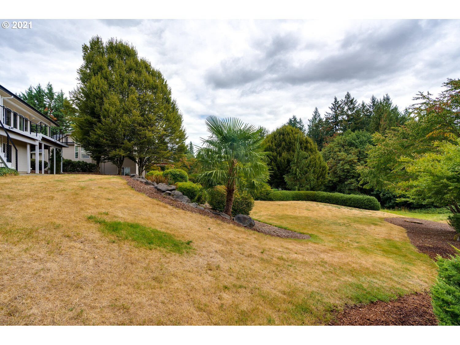 2170 South 26th Avenue Ridgefield, WA 98642 - Photo 32 of 32 a view of swimming pool with large trees and fence