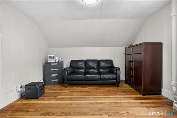 a living room with furniture and a bed
