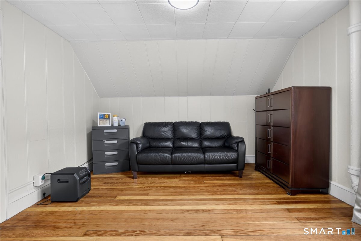 35 Marcel Street Bridgeport, CT 06606 - Photo 15 of 40 a living room with furniture and a bed