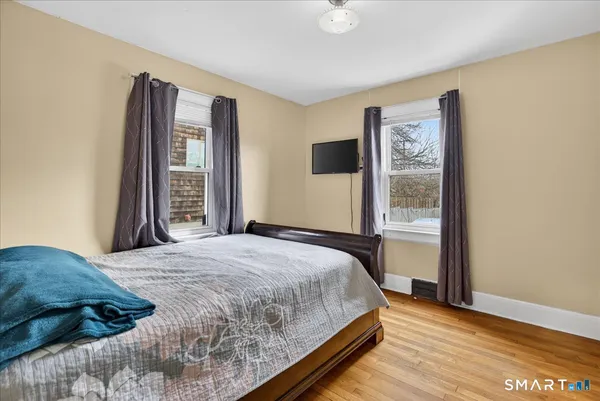a bedroom with a bed and a dresser in it