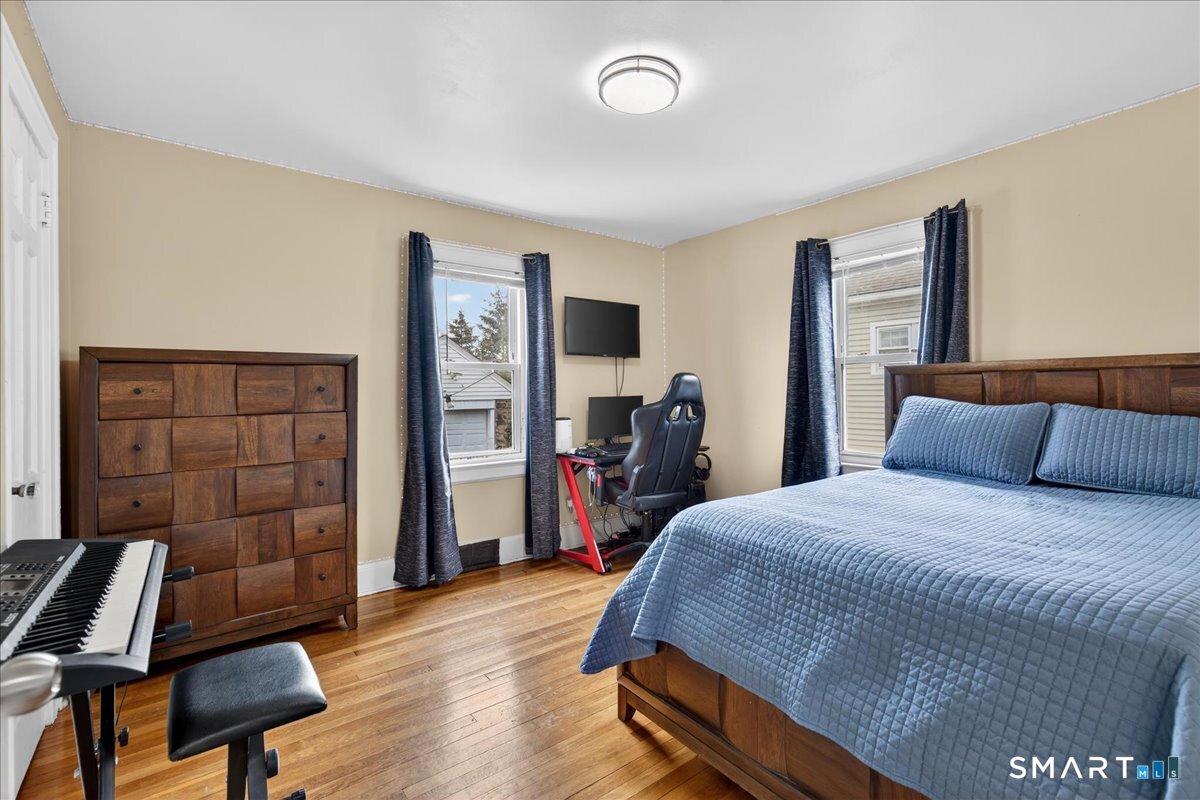 35 Marcel Street Bridgeport, CT 06606 - Photo 28 of 40 a bedroom with a bed and a dresser in it