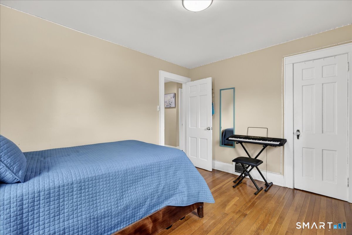 35 Marcel Street Bridgeport, CT 06606 - Photo 29 of 40 a bedroom with a bed and a table in it