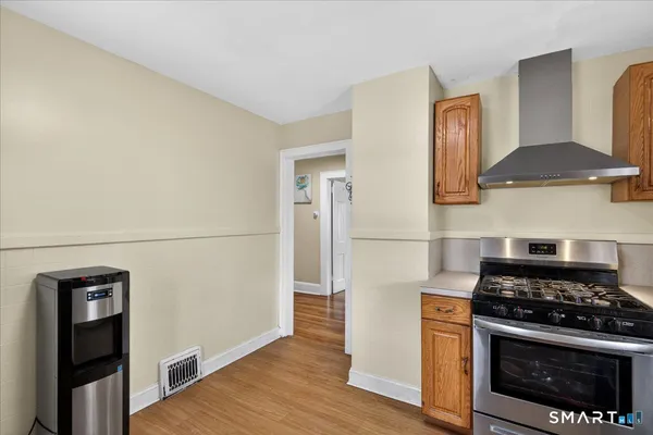 a kitchen with granite countertop a stove and a refrigerator