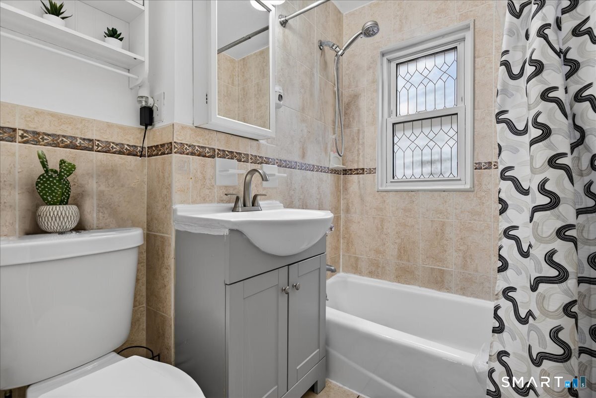 35 Marcel Street Bridgeport, CT 06606 - Photo 31 of 40 a bathroom with a sink a toilet and shower