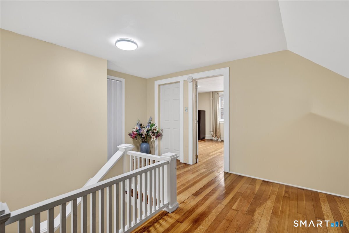 35 Marcel Street Bridgeport, CT 06606 - Photo 35 of 40 a view of a hallway with wooden floor and a bathroom