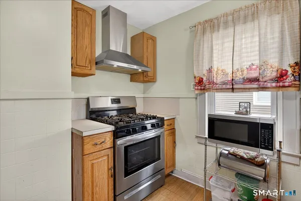 a kitchen with stainless steel appliances a stove and a microwave