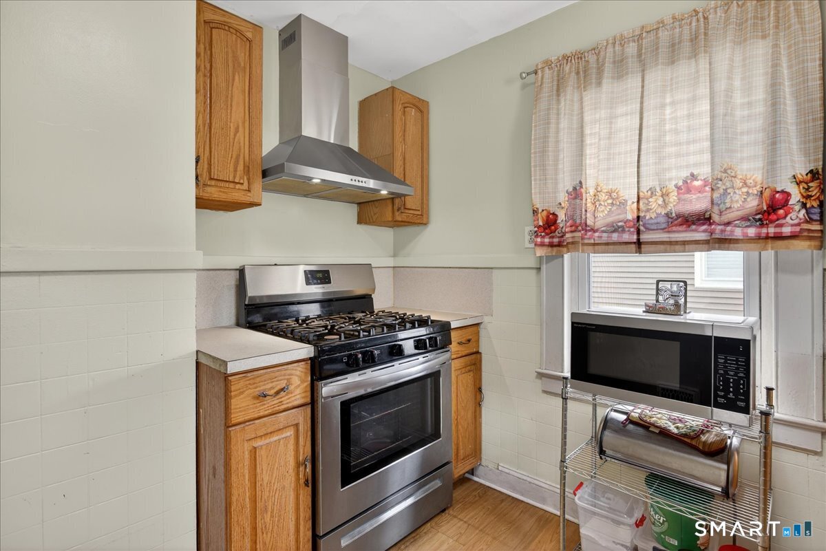 35 Marcel Street Bridgeport, CT 06606 - Photo 5 of 40 a kitchen with stainless steel appliances a stove and a microwave