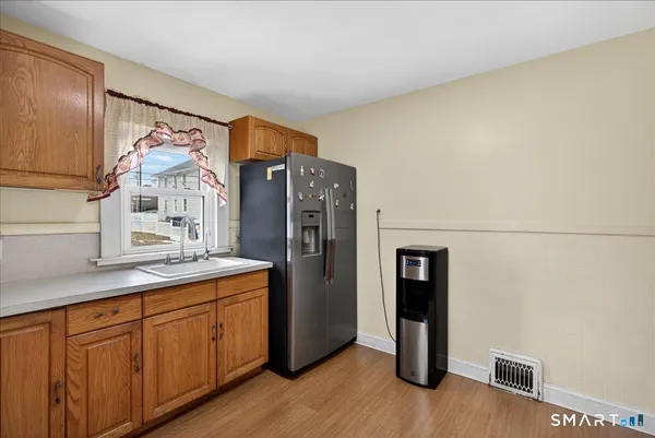a kitchen with stainless steel appliances granite countertop a refrigerator and a sink