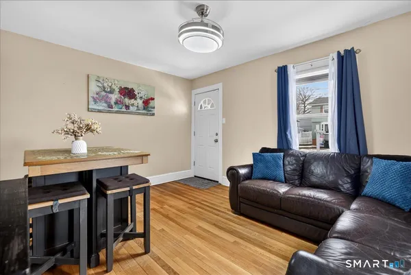 a living room with furniture and wooden floor