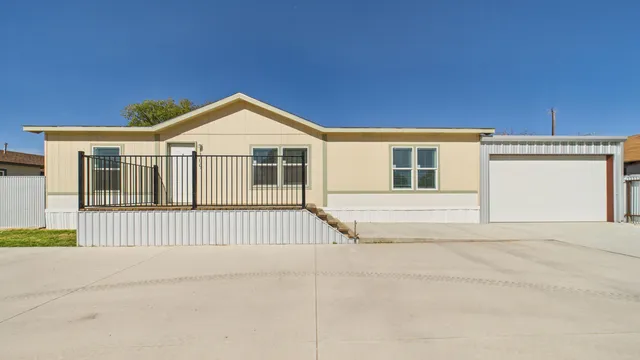 a view of a house with wooden fence
