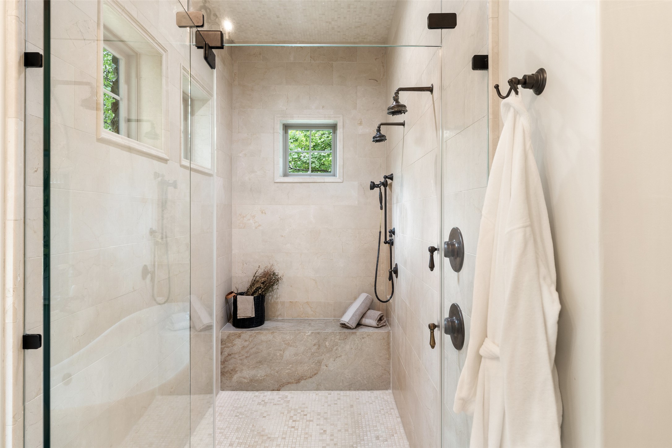 3667 Stoneridge Road Austin, TX 78746 - Photo 20 of 40 The walk-in shower is expansive and purposeful, featuring dual shower heads and a layout that emphasizes space, proportion, and ease.