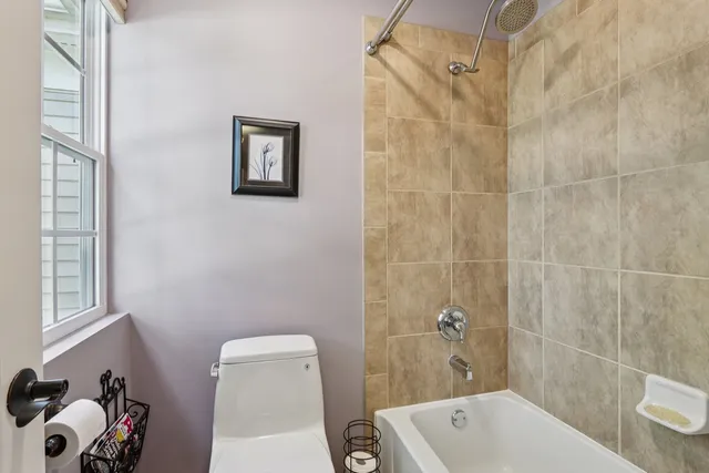 a bathroom with a toilet a bath tub and a shower