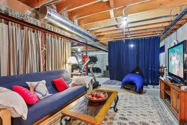 a living room with furniture a flat screen tv and a couch