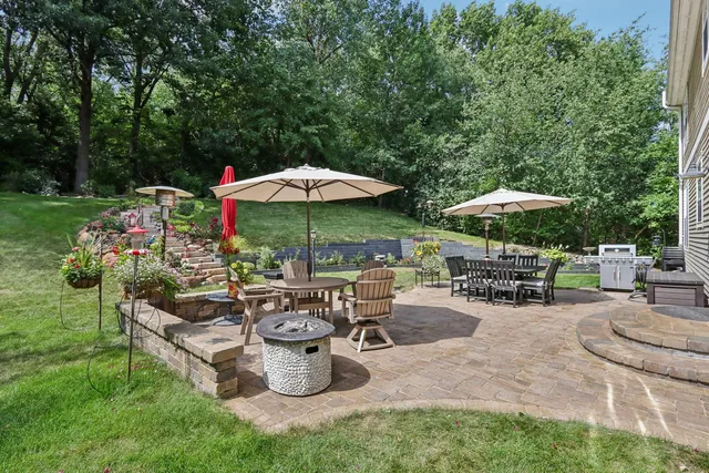 a view of a backyard with sitting area and a garden