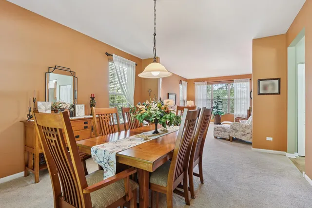 a dining room with furniture a chandelier and window