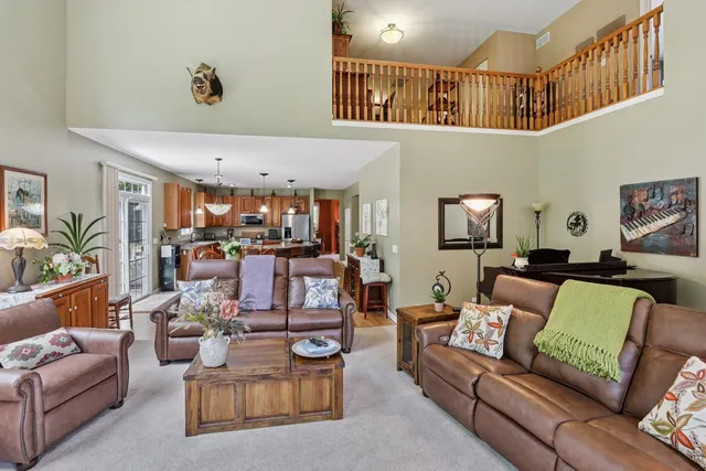a living room with furniture and a ceiling fan