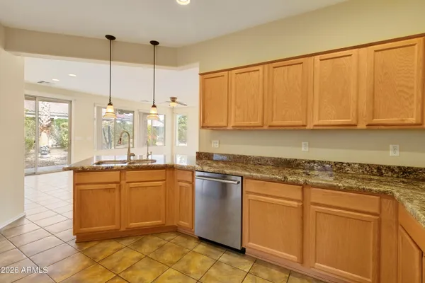 a kitchen with stainless steel appliances granite countertop a sink a stove and cabinets