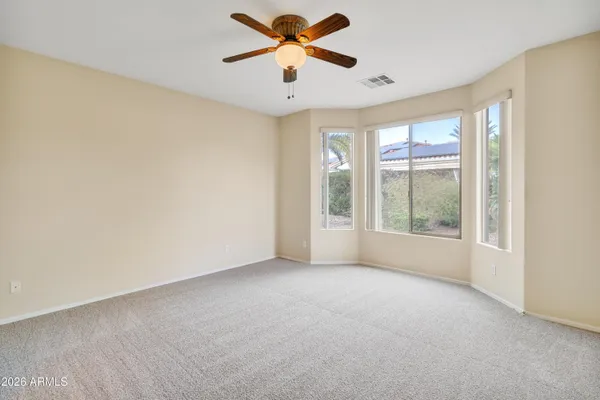 a view of a livingroom with a ceiling fan and window