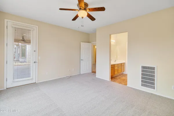 a view of a room with closet and ceiling fan